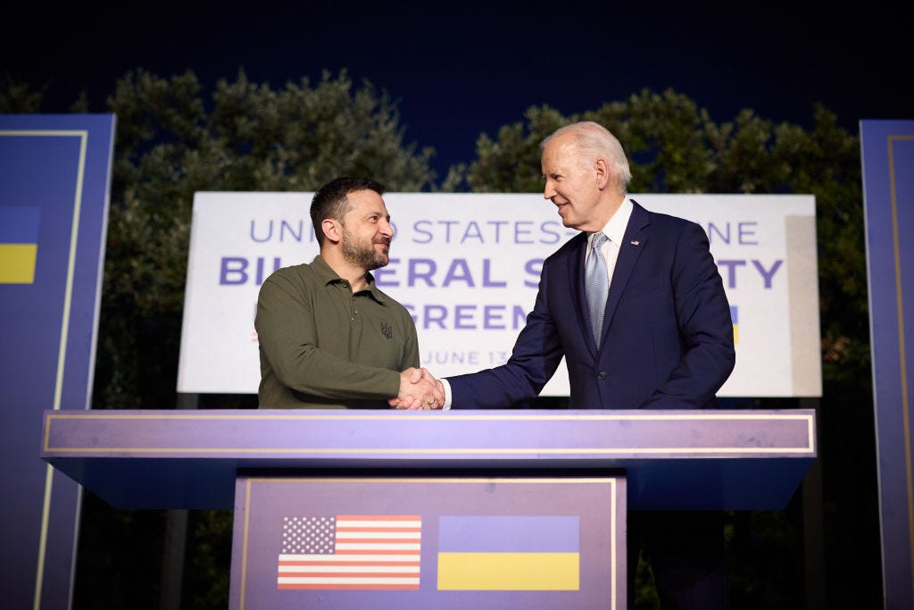 Ukrainian President Volodymyr Zelenskyy and US President Joe Biden shake hands during a joint press conference at the Masseria San Domenico on the sidelines of the G7 Summit hosted by Italy.