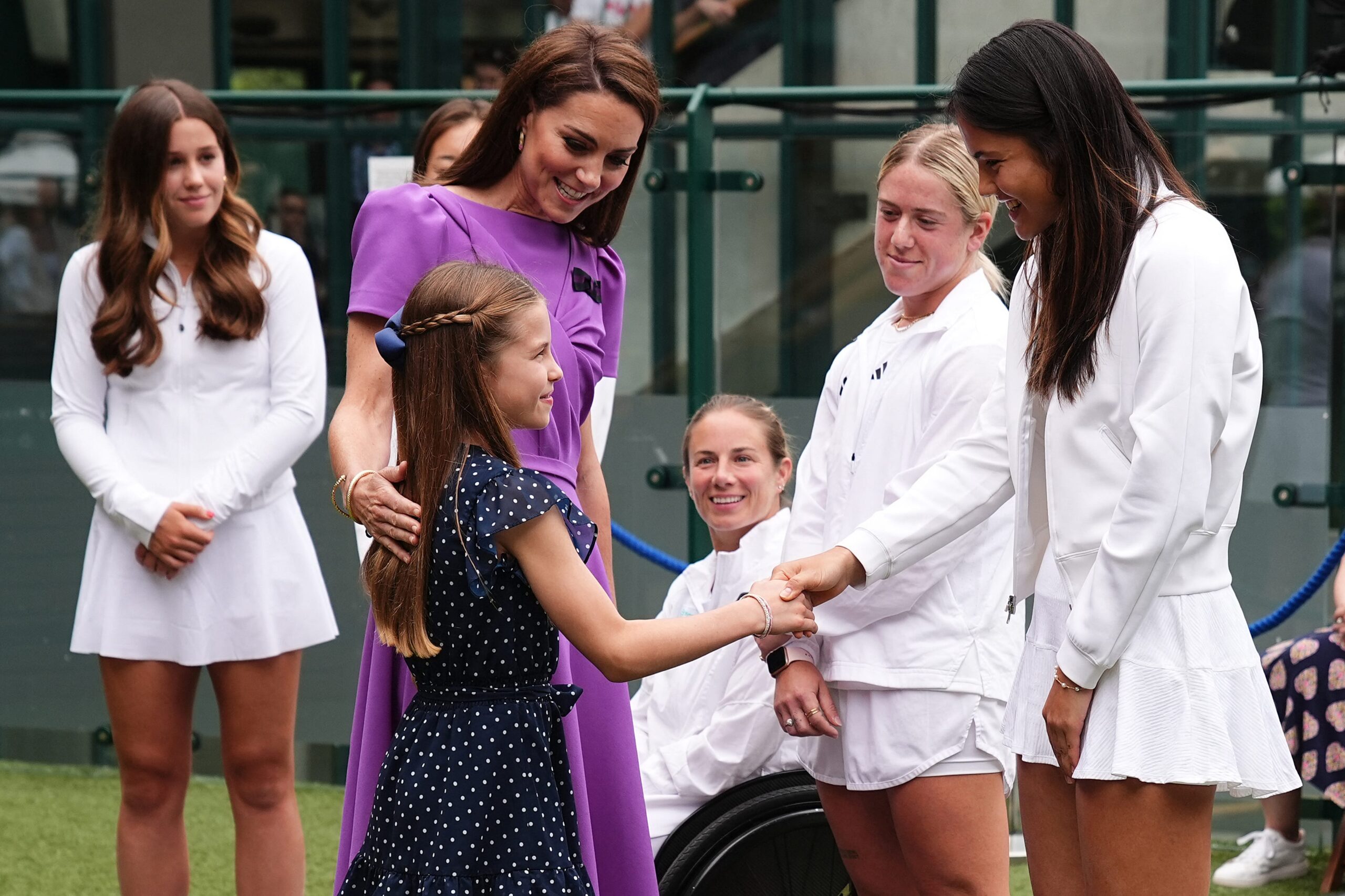 Britain's Catherine, Princess of Wales, and her daughter Britain's Princess Charlotte of Wales meet with Britain's Emma Raducanu before attending the men's singles final tennis match on the fourteenth day of the 2024 Wimbledon Championships at The All England Lawn Tennis and Croquet Club in Wimbledon, southwest London, on July 14, 2024.