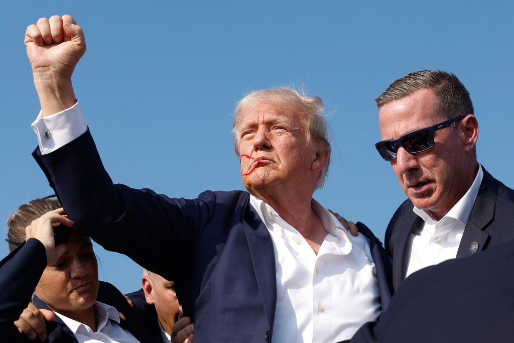 Donald Trump with his fist in the air after surviving a shooting.