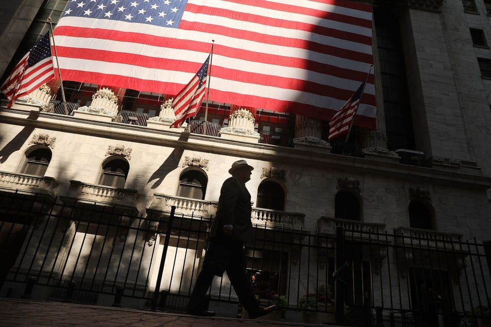 Photo of Wall Street with huge US flags