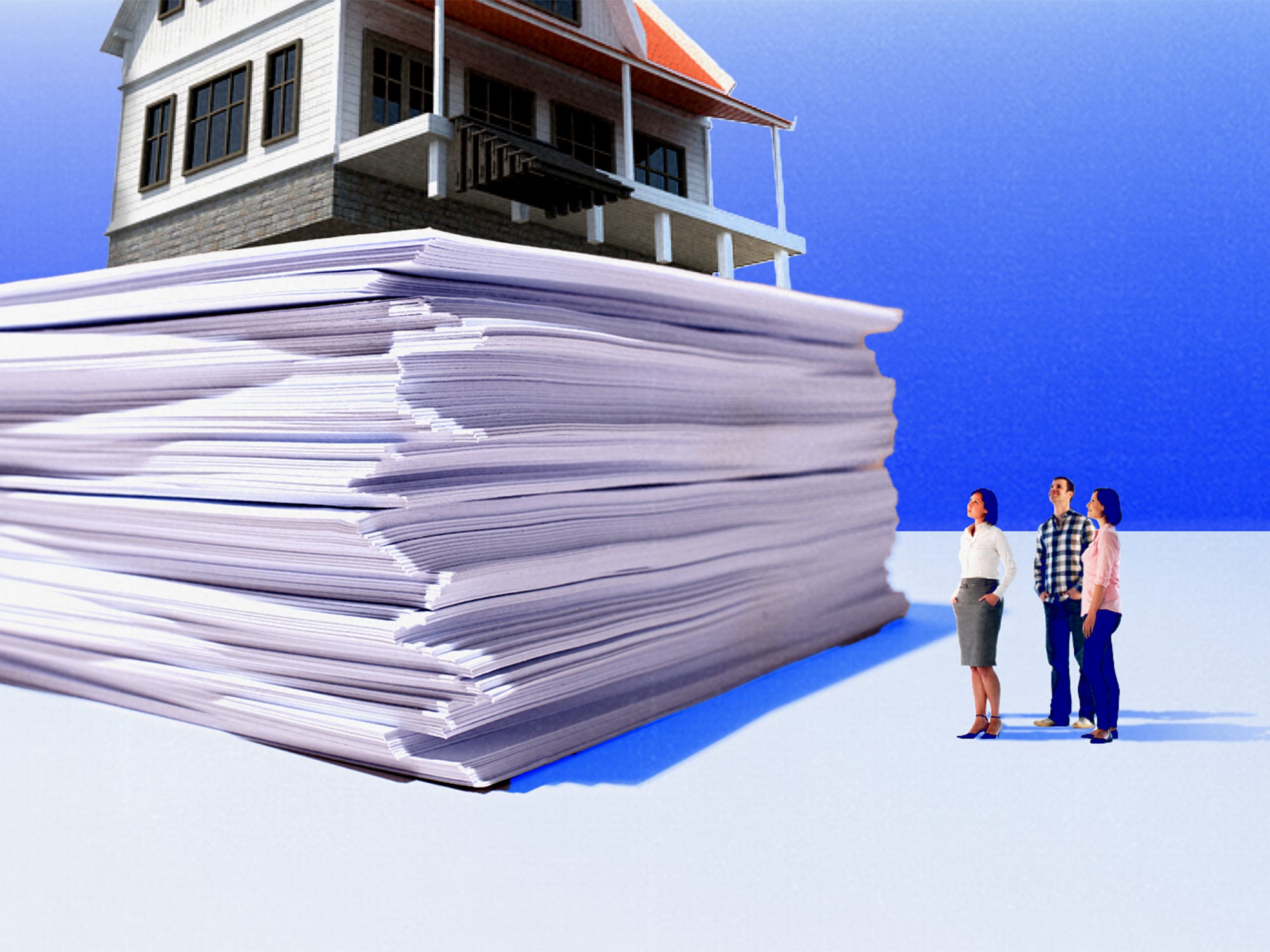 Real estate agent and future home buyers gazing up at stack of documents with a house perched at the top