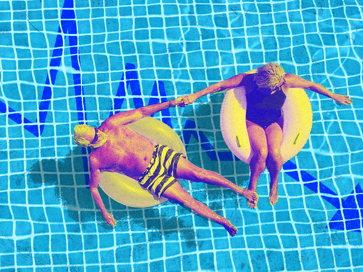 Senior couple enjoying a relaxing float in a pool with a downward trending stock line depicted at the bottom of the pool