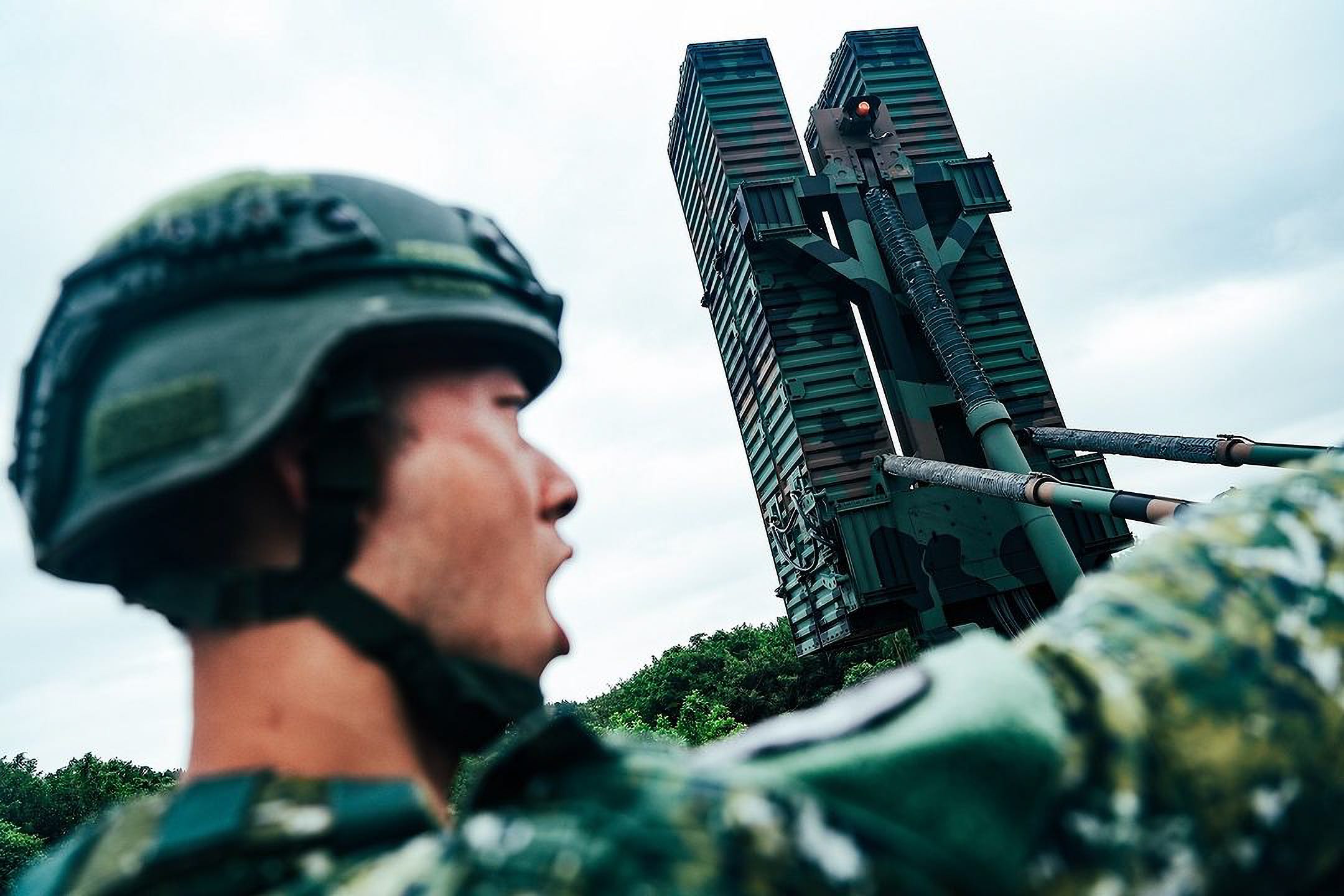 A Taiwanese soldier standing next to an air defense system.