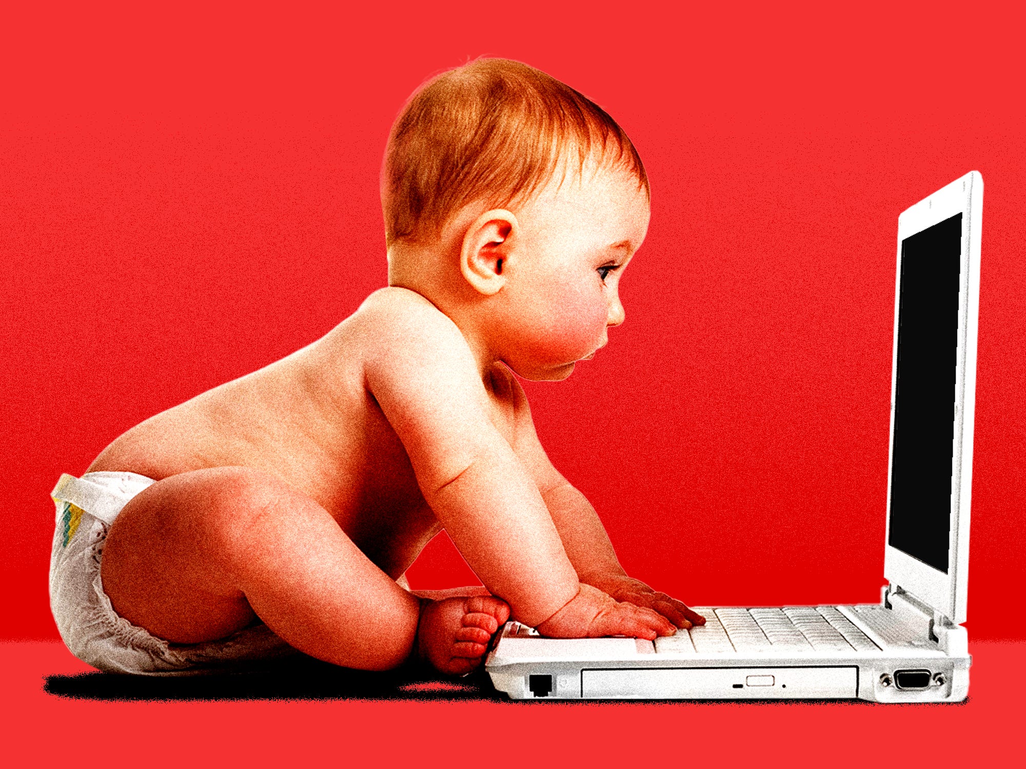 A baby staring at a laptop