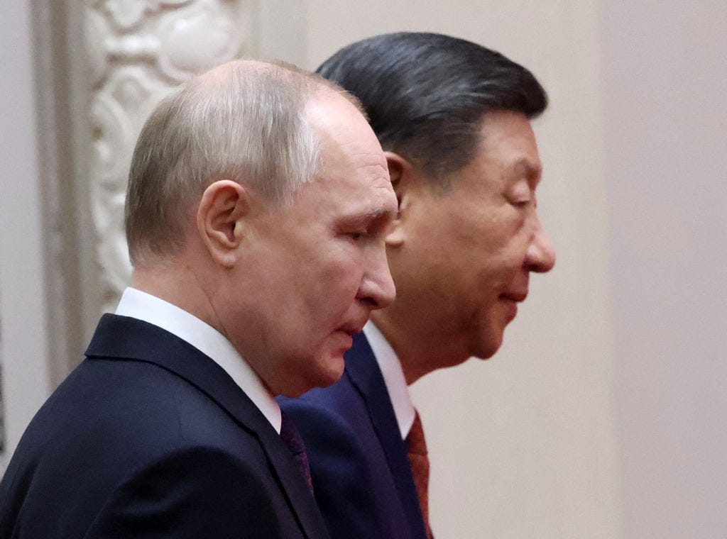 Russian President Vladimir Putin and Chinese President Xi Jinping enter the hall for Russian-Chinese talks on May 16, 2024 in Beijing, China.